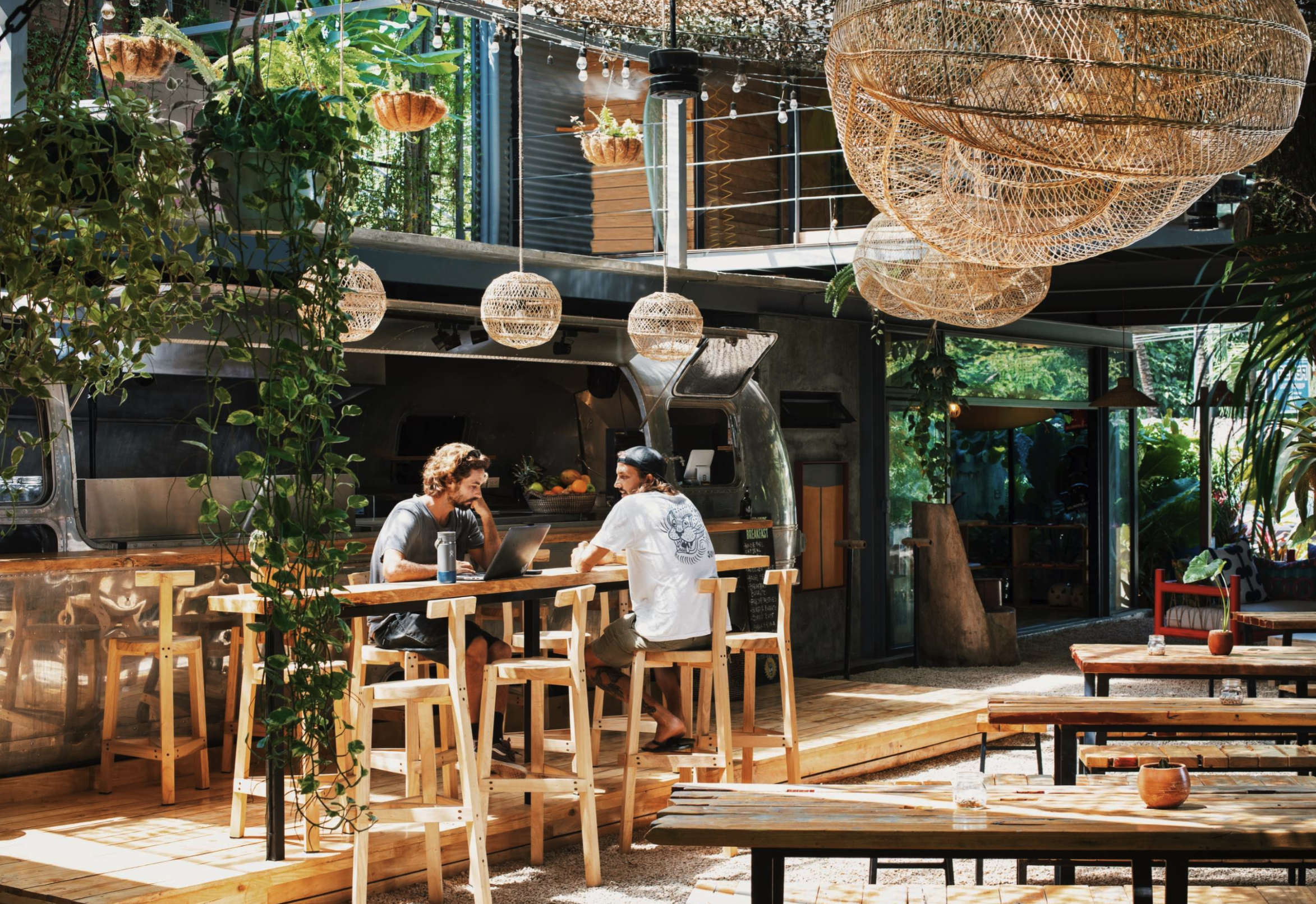 An open-air café in dappled morning sun