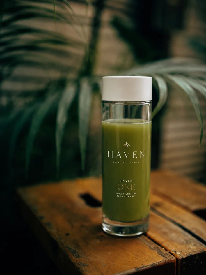 The prepared HAVEN ONE drink against foliage
